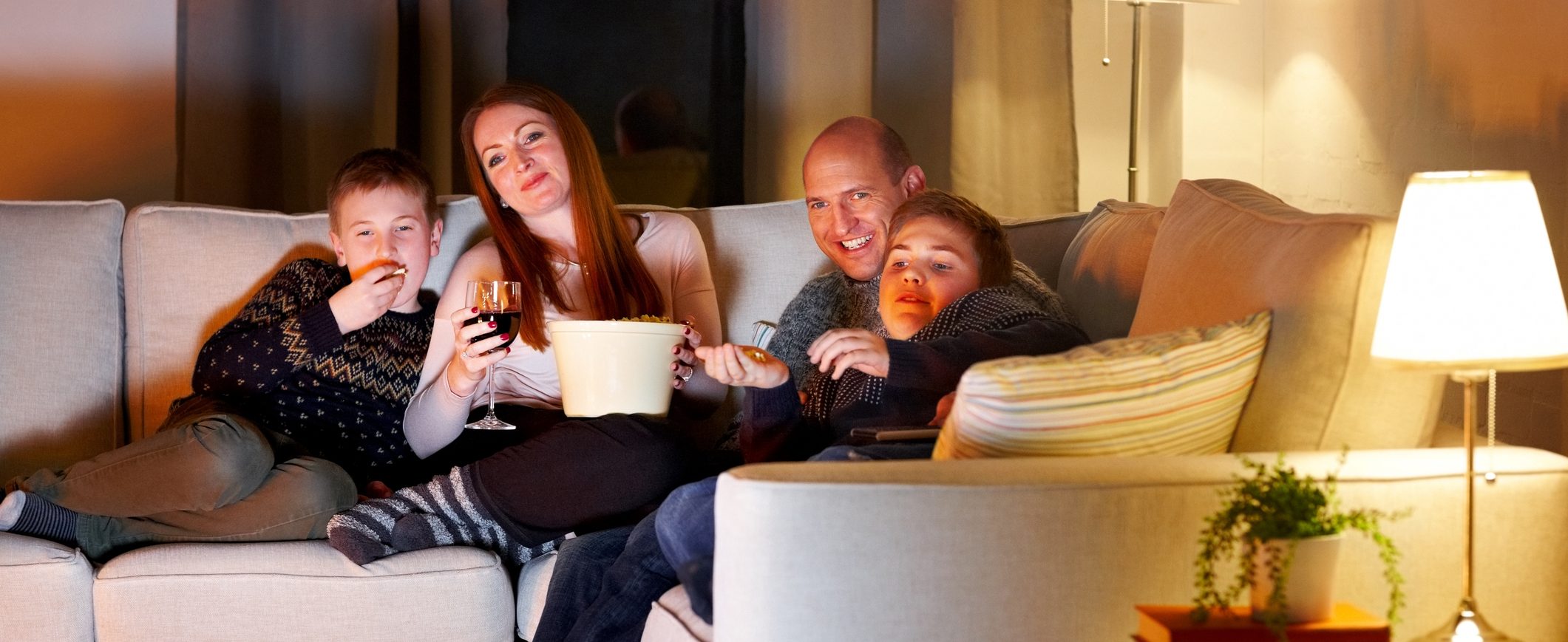 A family enjoys an evening at home rather than spending extravagantly on entertainment