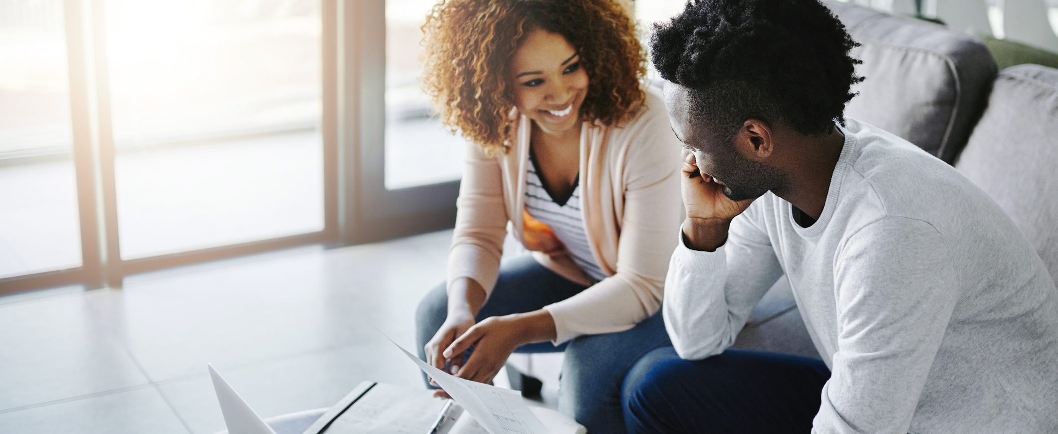 Young couple reviewing reasons to save money